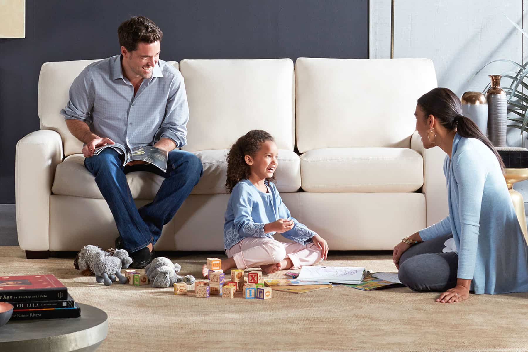 Family in Living Room With White Modern Couch