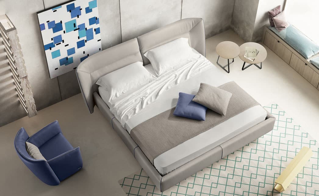 Modern and contemporary bedroom with bed, side tables and swivel chair