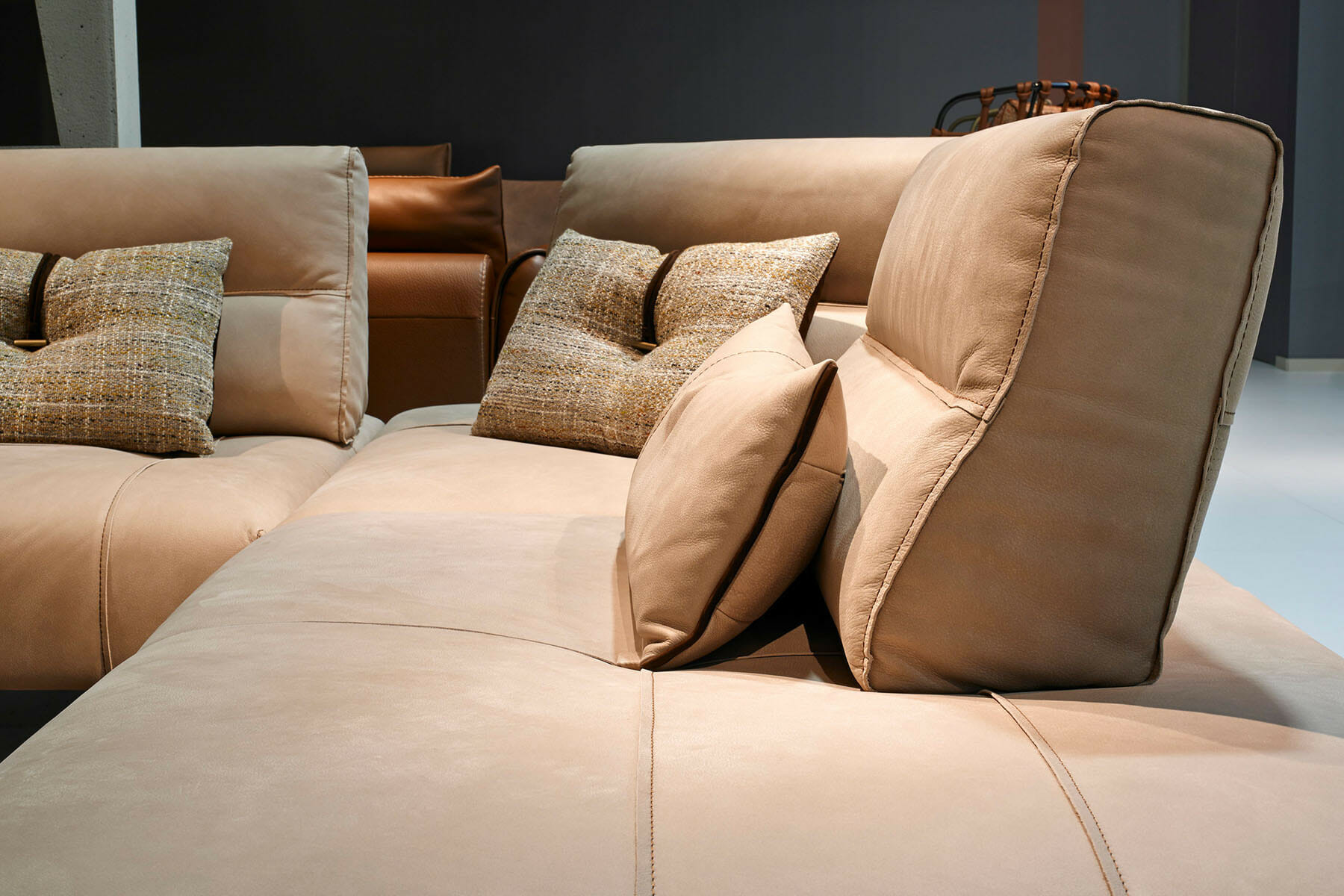 high end modern leather sofa with tan accent pillows