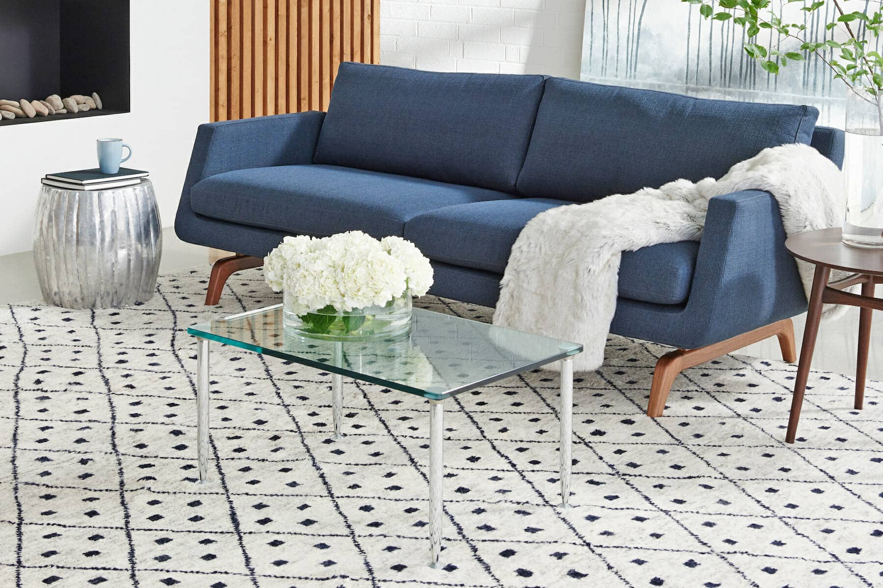 Contemporary navy blue sofa with mid century modern legs in Utah living room